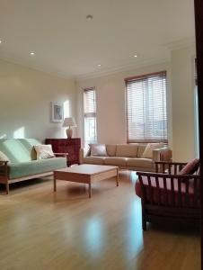 a living room with a couch and a table at Beautiful apartment in Kew, Richmond London with Free Underground Parking in London