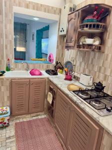 a kitchen with a stove and a sink at Maison sultana in Sousse