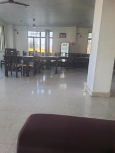 a dining room with tables and chairs and windows at Rest area 