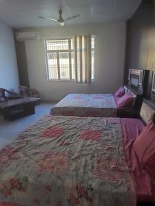 a bedroom with two beds and a rug on the floor at Rest area 