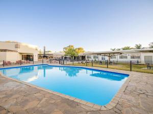 a swimming pool in the courtyard of a building at Mercure Hotel Windhoek in Windhoek