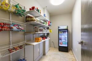 a walk in pantry with shelves and a refrigerator at California Building in New Orleans