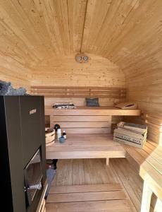 a sauna with wooden walls and a wooden ceiling at FeWo Olivia in Burghaun