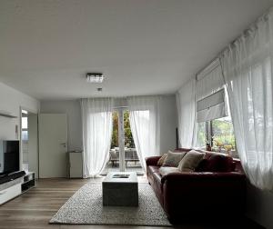 a living room with a couch and a table at FeWo Olivia in Burghaun