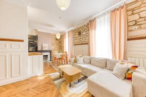 a living room with a couch and a table at Le Saint Mandé - Aux Portes de Paris & Vincennes in Saint-Mandé +23 photos