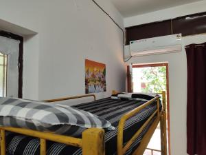 a bedroom with a bunk bed in a room at Sanchari hostel in Kuilapayam