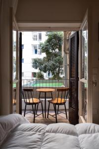 a bedroom with a bed and two chairs and a table at The Twin Bliss in Cairo +7 photos