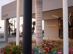 a building with columns and flowers in front of it at Novotel Arica in Arica