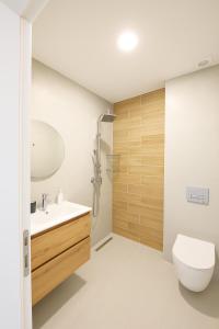 a bathroom with a toilet and a sink and a shower at Mono Alex Afitos in Afitos