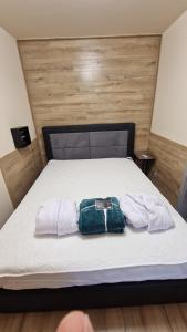 a bag sitting on top of a bed at Queen Emma's Place in Debrecen