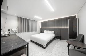 a hotel room with a bed and a desk at EG Stay Hotel in Gwangju +29 photos