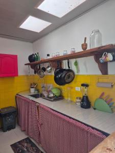 a kitchen with yellow tiles and a counter top at Casa rustica y familiar con piscina en La Vega Cund in La Vega
