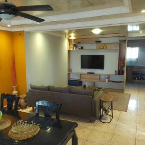 a living room with a couch and a flat screen tv at Chibu Backpackers Accommodation in Katima Mulilo