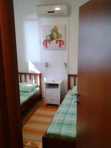 a small room with two beds and a desk at Villa Sol in Vinišće
