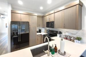 a kitchen with stainless steel appliances and wooden cabinets at Luxury Stay at The Vue in Saint George Municipal Airport