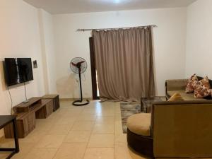 a living room with a couch and a tv at One Bedroom Chalet with Side Sea View ,Turtles, Hurghada Concierge D 14 6 in Hurghada