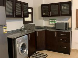 a kitchen with a sink and a washing machine at One Bedroom Chalet with Side Sea View ,Turtles, Hurghada Concierge D 14 6 in Hurghada