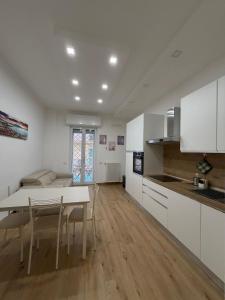 a kitchen and dining room with a table and chairs at CIAO PARTENOPE - luxury rooms in Naples