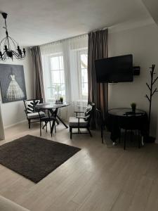 a living room with a table and a tv at Old town apartment in Vilnius