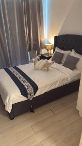 a large bed sitting in a room with at Zelle Luxxe - Azure Staycation Resort in Manila