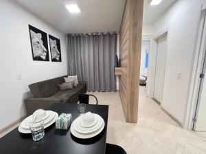 a living room with a black table and a couch at LK Centro 10 in Belo Horizonte