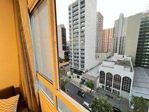 a view of a city from a window at LK Centro 10 in Belo Horizonte +25 photos