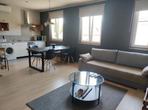 a living room with a couch and a table at Deák Houses in Nagykőrös