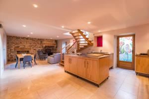 a kitchen with a staircase and a dining room at Sejour prestige a Lannion entre ville et plages in Lannion