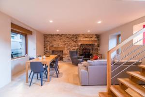 a living room with a table and a couch at Sejour prestige a Lannion entre ville et plages in Lannion
