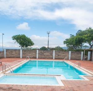 a swimming pool on top of a brick wall at Topcliff Lodge in Nakuru