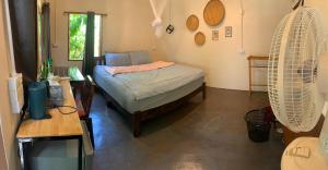 a bedroom with a bed and a fan at บ้านใจแปงโฮมสเตย์ Ban Jaipang Homestay in Pai +131 photos