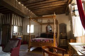 a bedroom with a canopy bed in a room at Les Trois Maillets, Monument Historique in Orléans