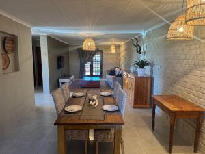 a dining room with a wooden table and chairs at The Pecan Cottage in Somerset East