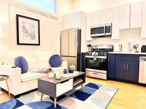 a living room with a white couch and a kitchen at Cozy 1BR Apt Downtown Steps from Convention Center in Providence +14 photos