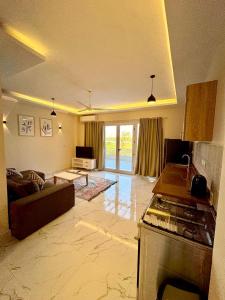 a living room with a couch and a table in a room at Royal Nile Villa - Luxury Nile Sky Penthouse 2 in Al Aqālitah