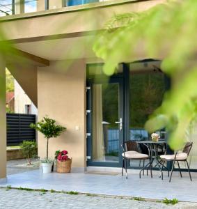 a patio with chairs and a table in front of a house at KalyNove апартаменти in Verkhniy Yasenov +4 photos