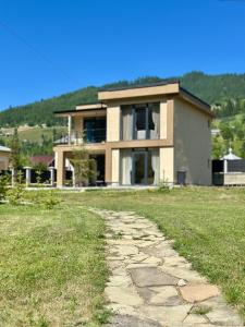 a house with a stone path in front of it at KalyNove апартаменти in Verkhniy Yasenov