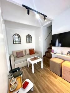 a living room with a couch and a tv at Best of Tangiers Heart in Tangier