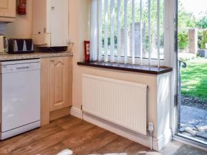 a kitchen with a dishwasher and a window at Swallow Cottage - Uk49756 in Little Singleton