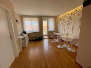a kitchen with two tables and chairs in a room at Sesto Quaranta in Palermo