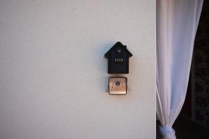 an electrical switch on a wall next to a curtain at Les Gîtes W elles come in Cotignac