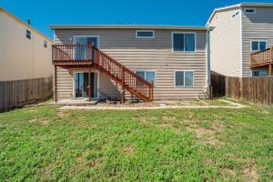 a house with a deck and a yard at The Cozy Oak - 4BR Family Home in Fountain