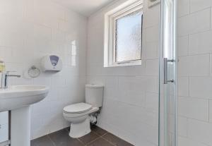 a white bathroom with a toilet and a sink at No 3 Georgian Shared House - By Clifton Short Lets in Bristol