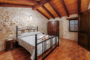 a bedroom with a bed and a wooden floor at Villa Radetici in Radetići +45 photos
