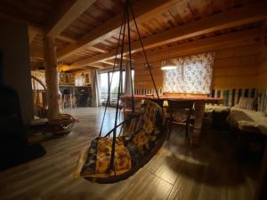 a room with a hanging hammock in a house at Chata u Strýčka in Dolný Kubín +4 photos