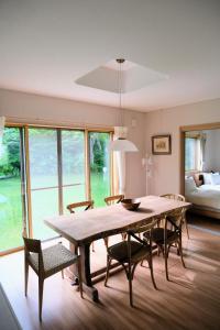a dining room with a large wooden table and chairs at Meanwhile Woods in Myoko