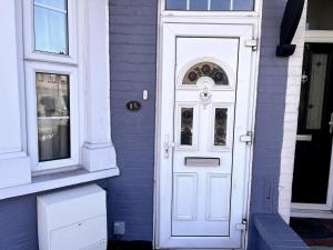 a white door on the side of a house at Relax & Explore 3bed Home with Easy London Access in Harrow Weald