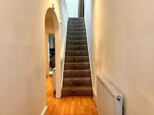 a staircase in a house with a stair case at Relax & Explore 3bed Home with Easy London Access in Harrow Weald +21 photos