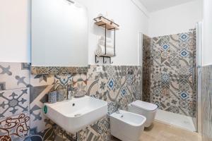 a bathroom with a sink and a toilet at I Due Mori Marzamemi in Marzamemi +23 photos
