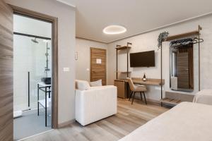 a hotel room with a bedroom with a desk and a chair at Pula City Center Accommodation - Breakfast included in Pula